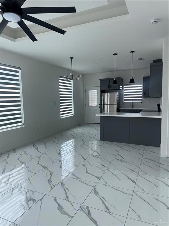 Spacious kitchen with stainless steel appliances. Light countertops create a bright and modern feel.  Come on in!