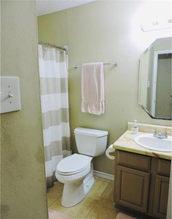 Full bath with tile patterned floors, vanity, and