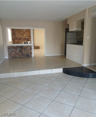 Unfurnished living room featuring tile patterned f