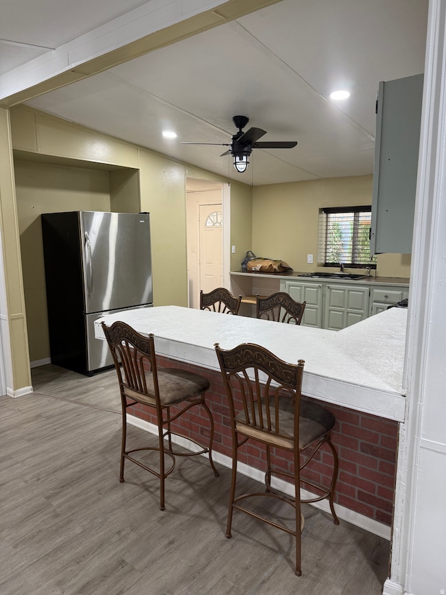 Dining room featuring light wood finished floors, ceiling fan, and recessed lighting