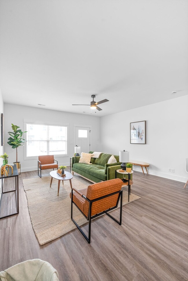 Living room with LVP flooring and ceiling fan