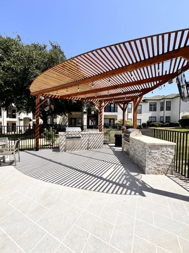 View of patio / terrace featuring exterior kitchen and a pergola