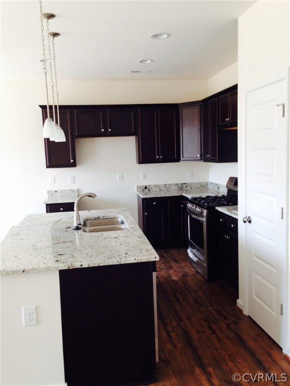 Kitchen with Granite counter tops, gas stove and r