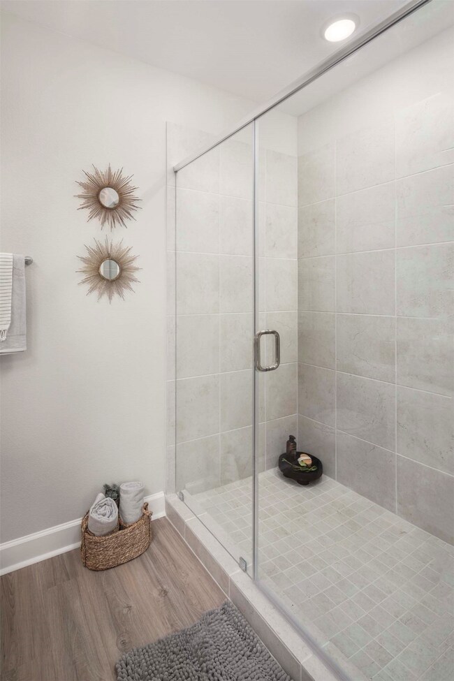 Primary bath double sink vanity and glass enclosed