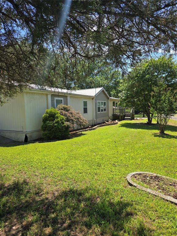 View of green lawn with a deck
