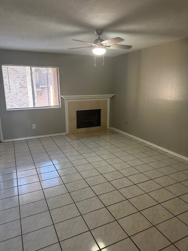 Roomy living room with fireplace.