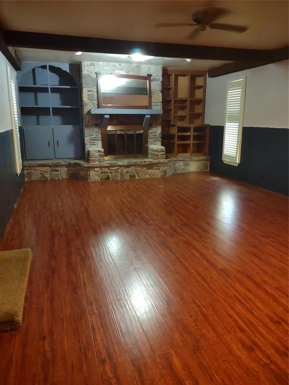 Unfurnished living room with beam ceiling, hardwoo