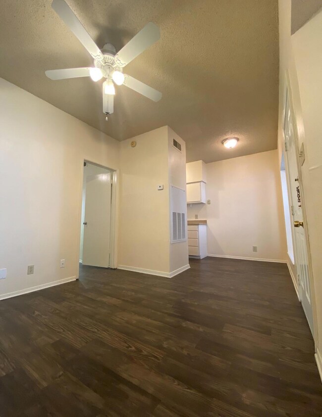 Unfurnished living room featuring dark wood finis