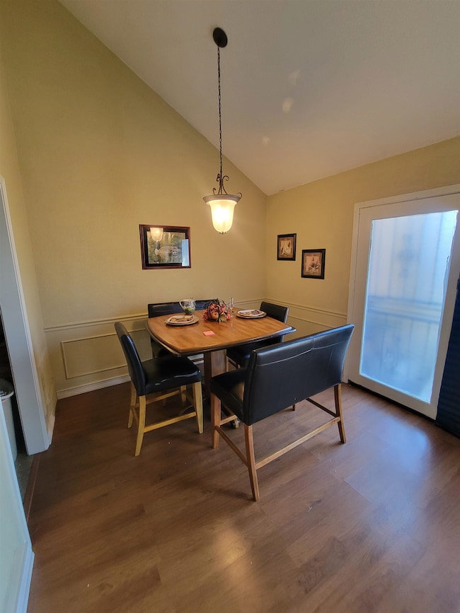 Dining space featuring dark wood-type flooring and