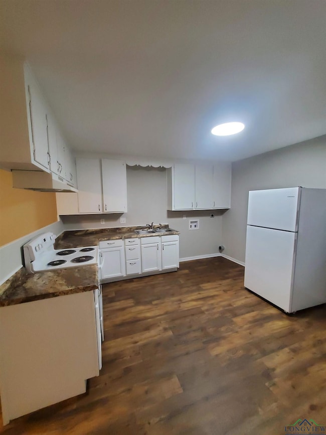 Kitchen with white appliances, dark hardwood / woo