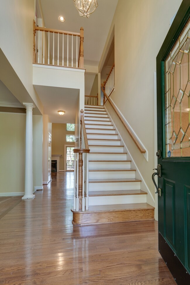Stunning entrance into home with 2 story ceiling, hardwood floor and staircase!