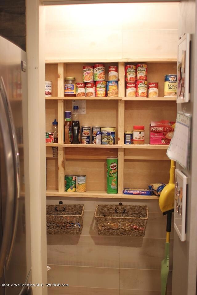 kitchen pantry with microwave storage