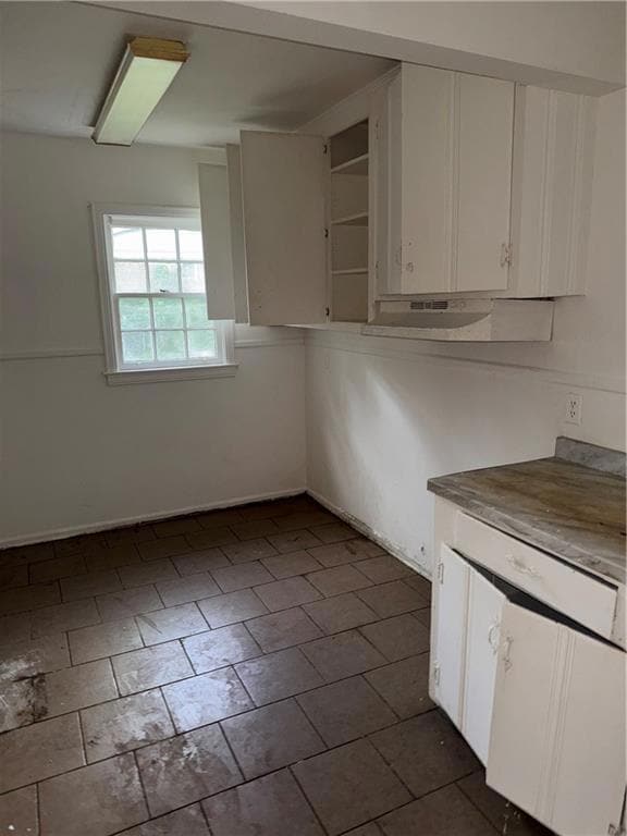 Kitchen featuring white cabinetry