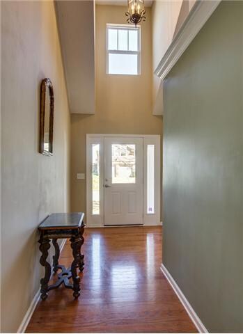 Soaring ceilings and natural light welcome you into this charming home!