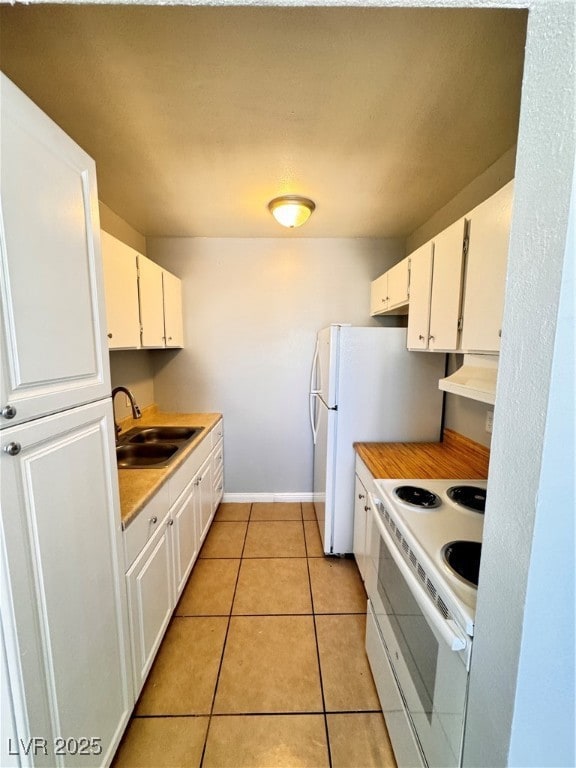 Kitchen with range, a sink, light countertops, whi