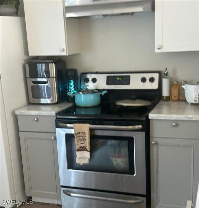Kitchen featuring electric range, freestanding ref