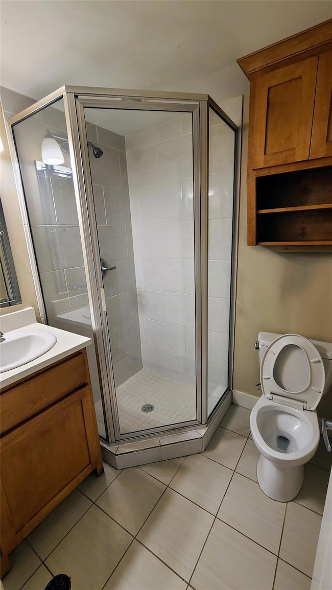Bathroom featuring vanity, tile patterned floorin