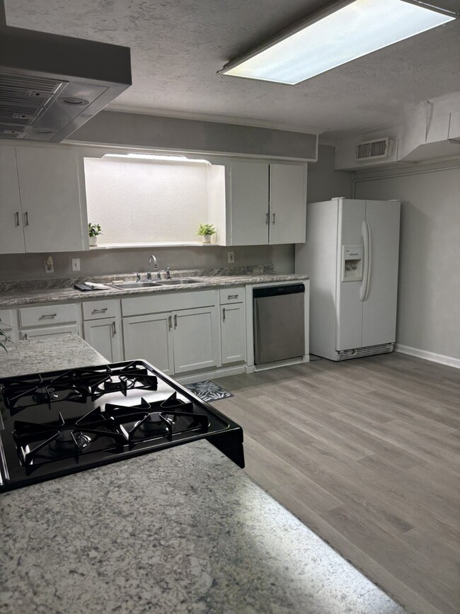 Another view of oversized kitchen/dining area.