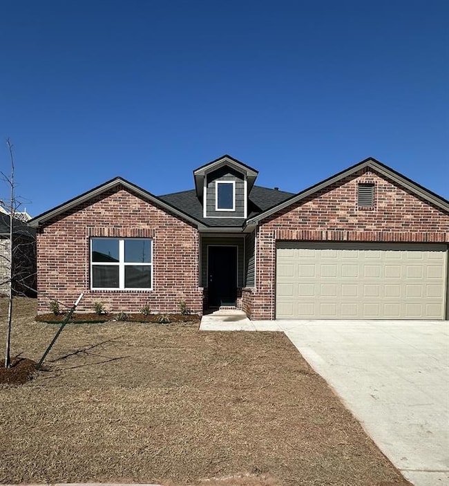 Ranch-style home with concrete driveway, brick sid