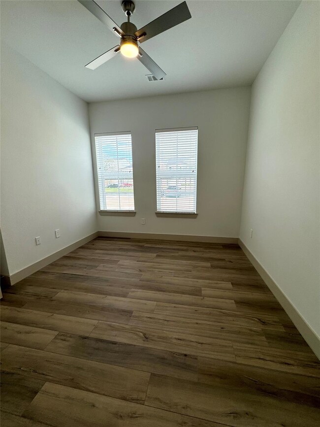 Empty room with dark hardwood / wood-style floors 