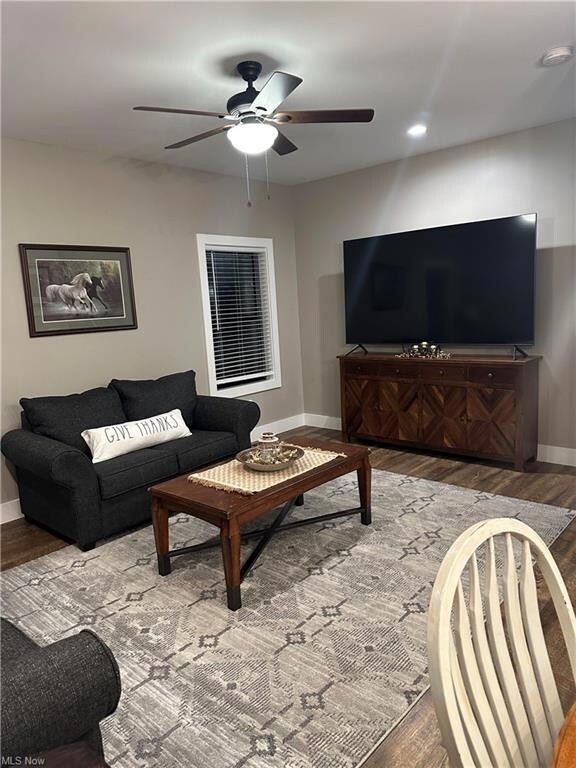 Living room with hardwood flooring and ceiling fan