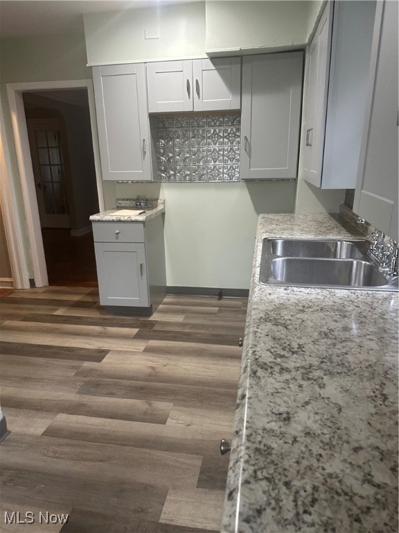 Kitchen with gray cabinetry and dark wood-style floors