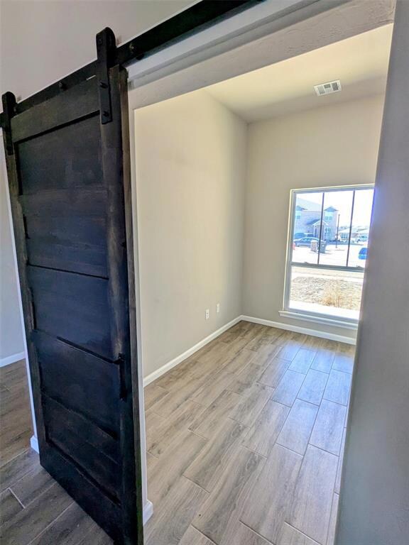 Empty room featuring wood finished floors, visible