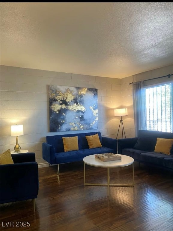 Living area featuring a textured ceiling and wood finished floors