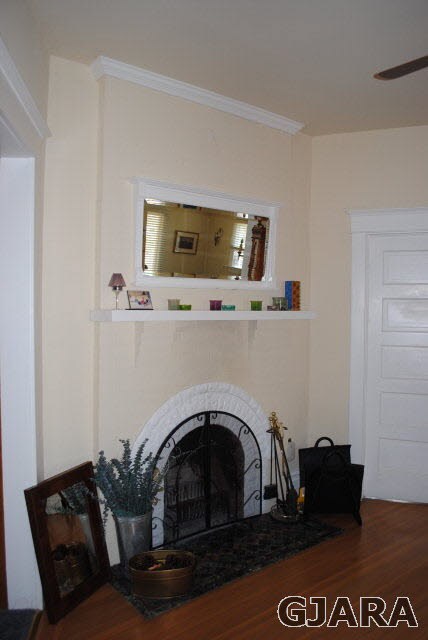 Foyer entrance with gas fireplace, orginal mirror 