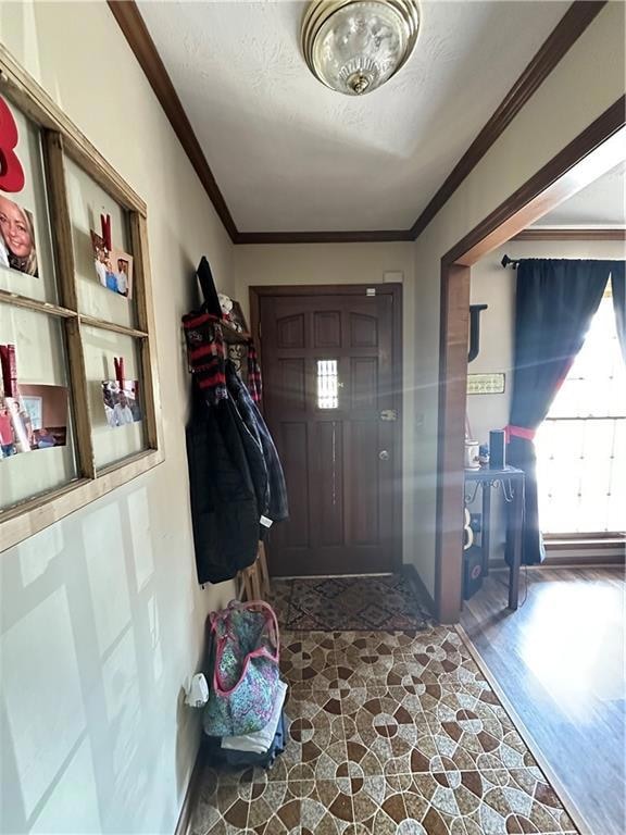 Entrance foyer featuring a textured ceiling, crown