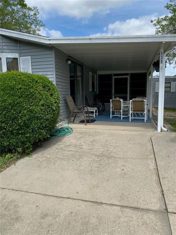 THE COVERED CARPORT IS BEING USED AS A PATIO AREA