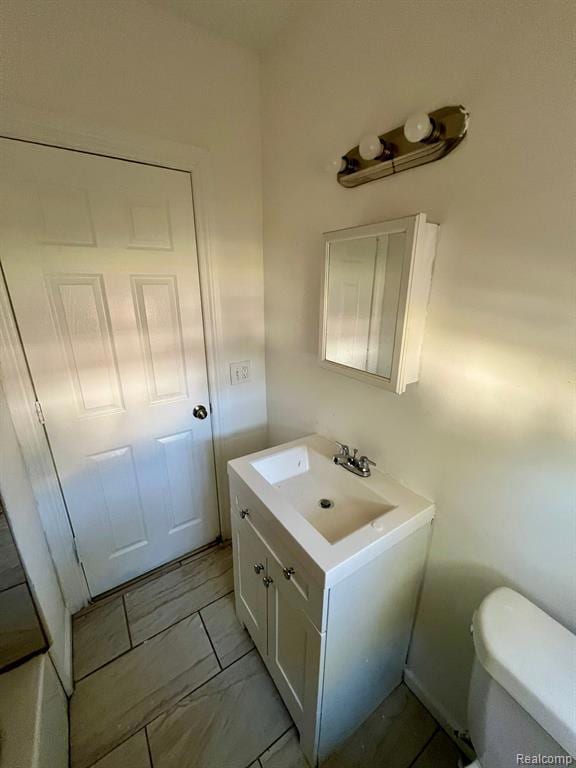 Half bath with vanity and toilet