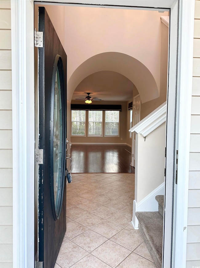 Foyer entrance featuring light tile patterned floo