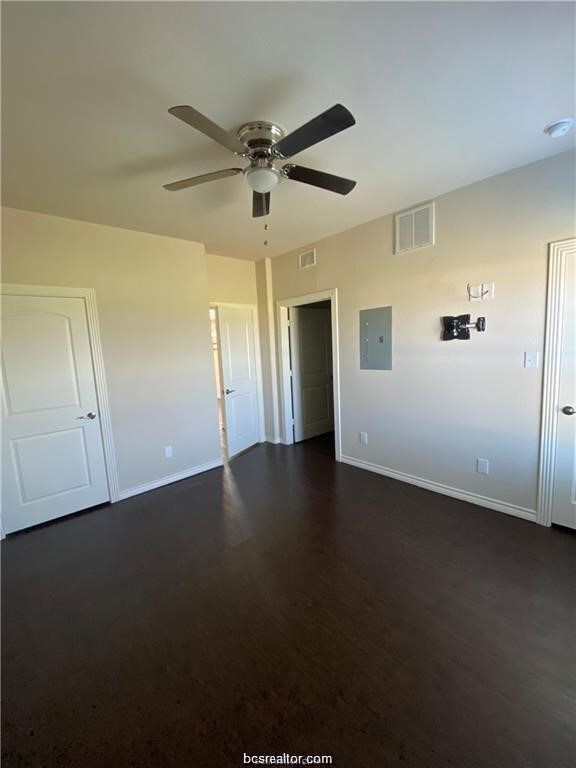 Spare room with ceiling fan, dark wood finished fl
