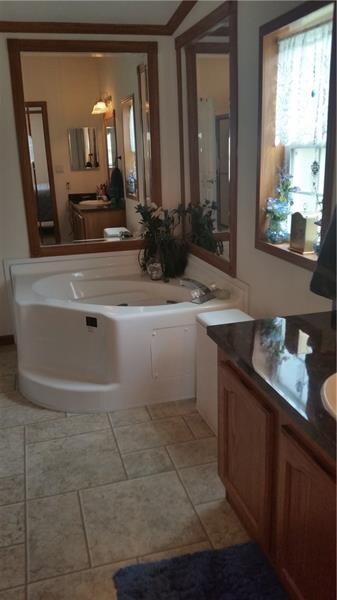 Soaking tub in the master bath which also has a la