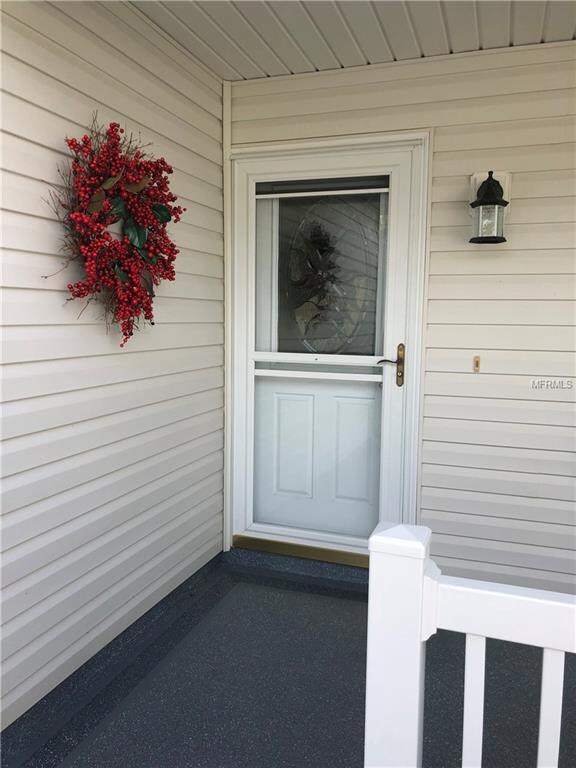 Decorative glass door with storm door welcomes you