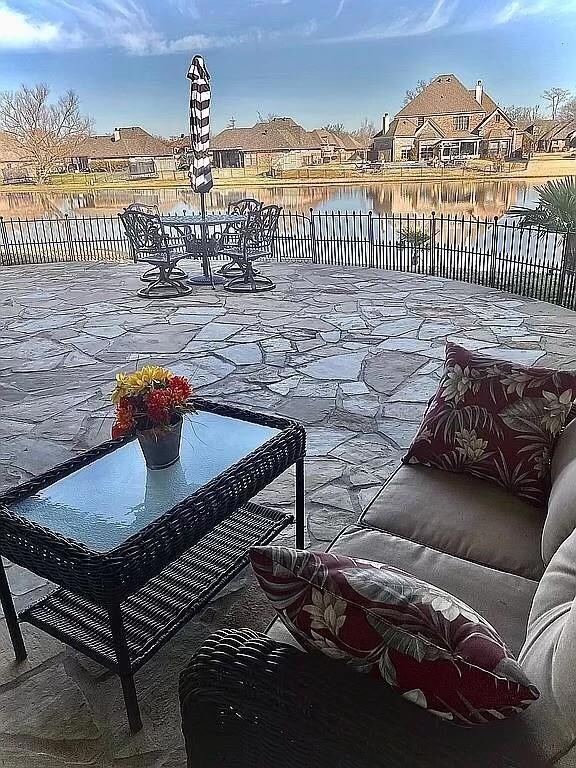 View of patio / terrace featuring a water view