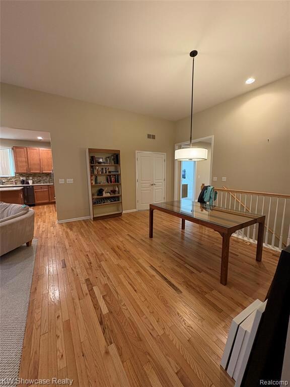 Dining space with recessed lighting and light wood-style floors