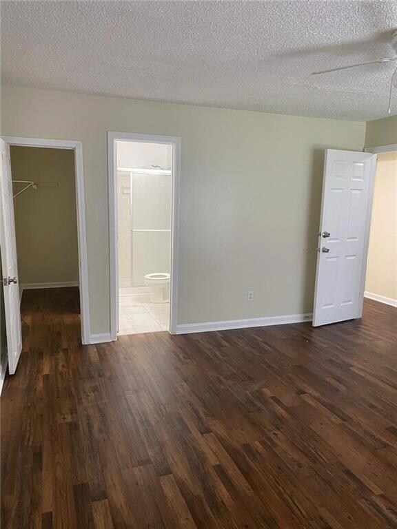 Spare room with dark hardwood / wood-style floors 