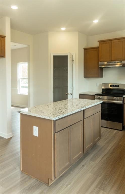 Kitchen with light wood-type flooring, electric st