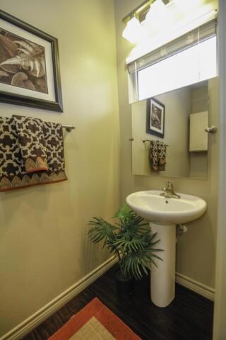 Bathroom with baseboards and wood finished floors