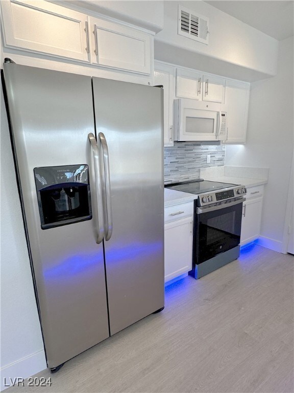 Built-in side by side fridge with cabinet above