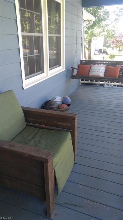Inviting front porch to sit and watch the birds..
