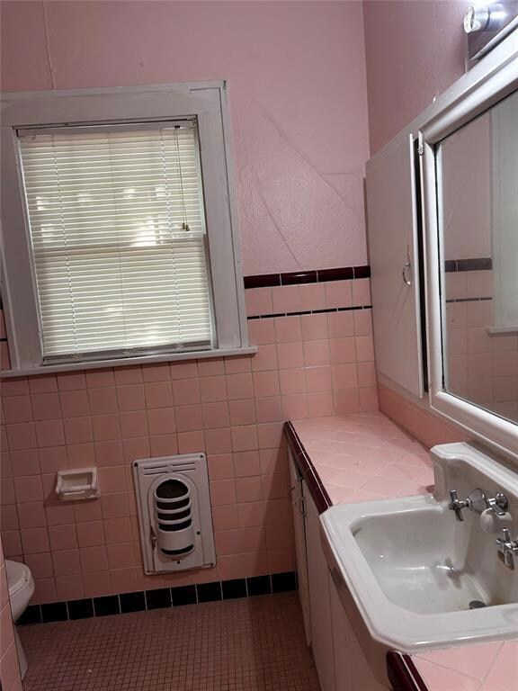 Bathroom featuring tile walls, tile patterned floo