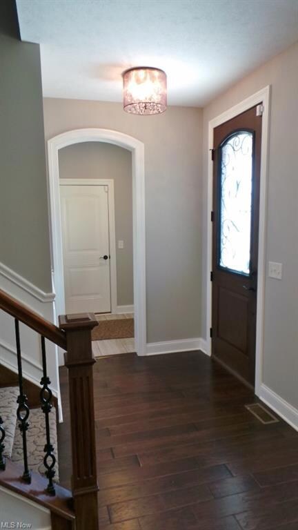 Welcoming Front Foyer with Designer Stained Solid 