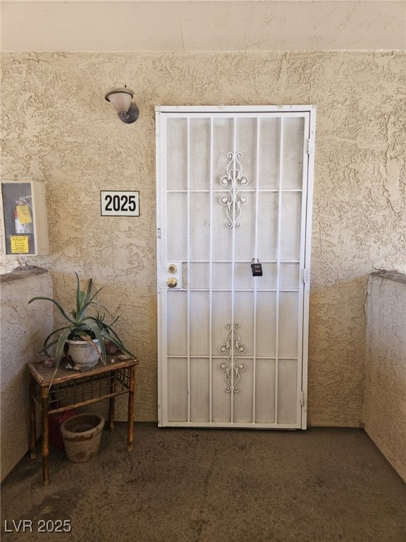 Doorway to property with stucco siding