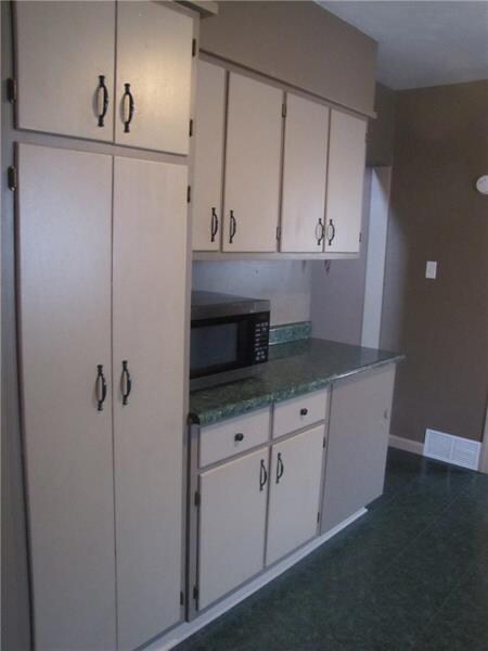 This side of the kitchen features a floor to ceili
