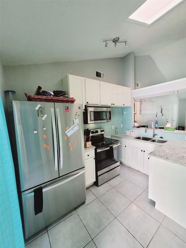 Kitchen featuring stainless steel appliances, sink