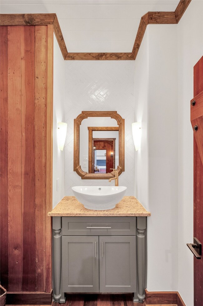 The powder room has  elegant Glazed Italian tile,