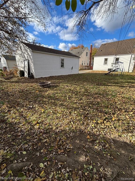 Rear view of house featuring a yard